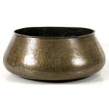 A large brass bowl decorated with a continual figural Egyptian scene, 43cms (17ins) diameter.