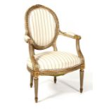 A 19th century French painted & gilded fauteuil with upholstered seat and back, on tapering reeded
