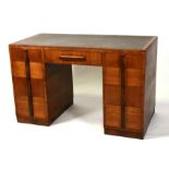 A Waring & Gillows Art Deco walnut pedestal desk with an arrangement of nine drawers, 122cms (48ins)