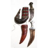 A Middle Eastern Jambiya dagger in a leather scabbard with red glass cabochons, 33cms (13ins)