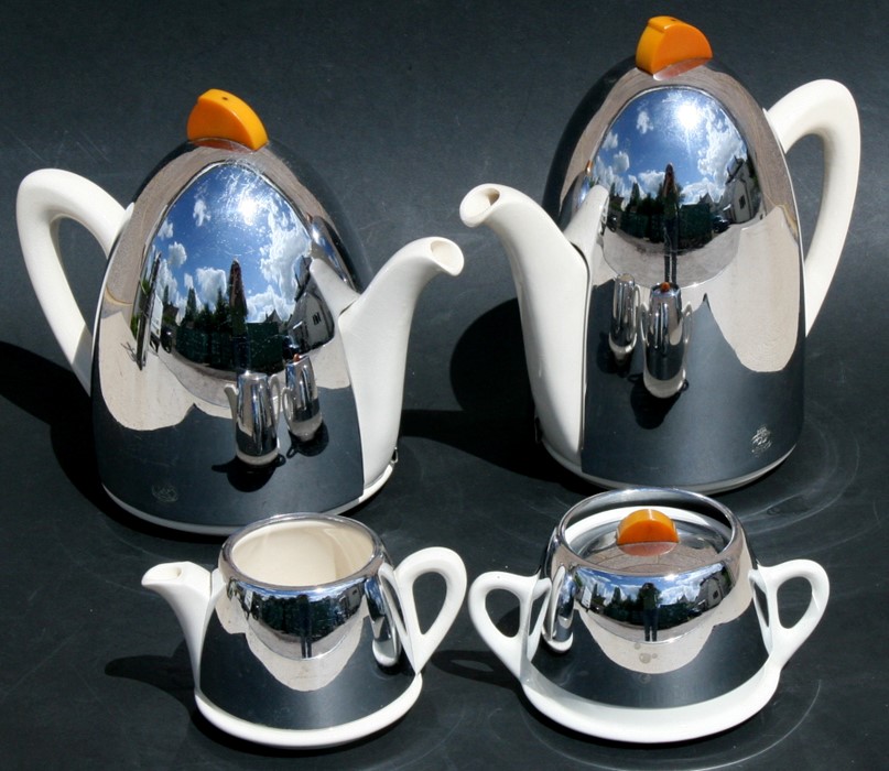 An Art Deco KK tea set with chrome covers and phenolic handles, consisting a teapot, hot water