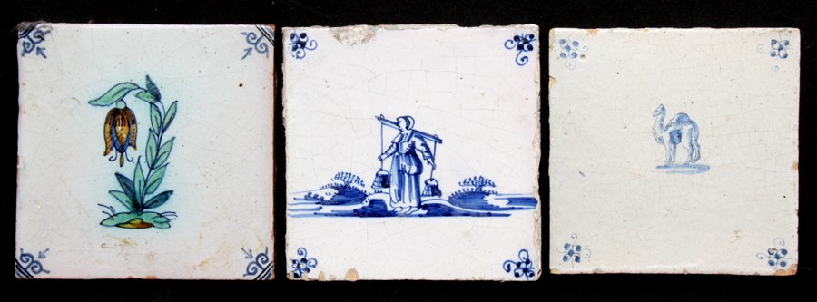 Three Delft blue & white tiles, 13cms (5ins) wide (3).