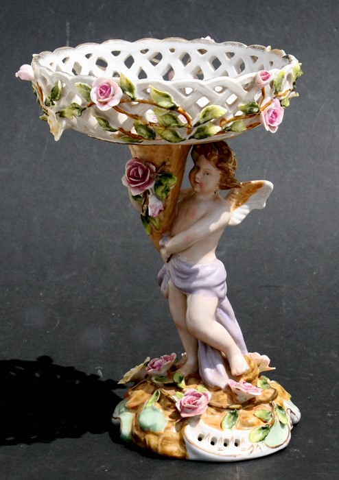 A continental porcelain figural stand, 22cms (8.5ins) high.