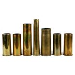 Seven assorted brass shell cases. The tallest being 31cms (12.25ins)