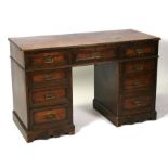 An late 19th / early 20th century oak pedestal desk with an arrangement of nine drawers. 121cm (