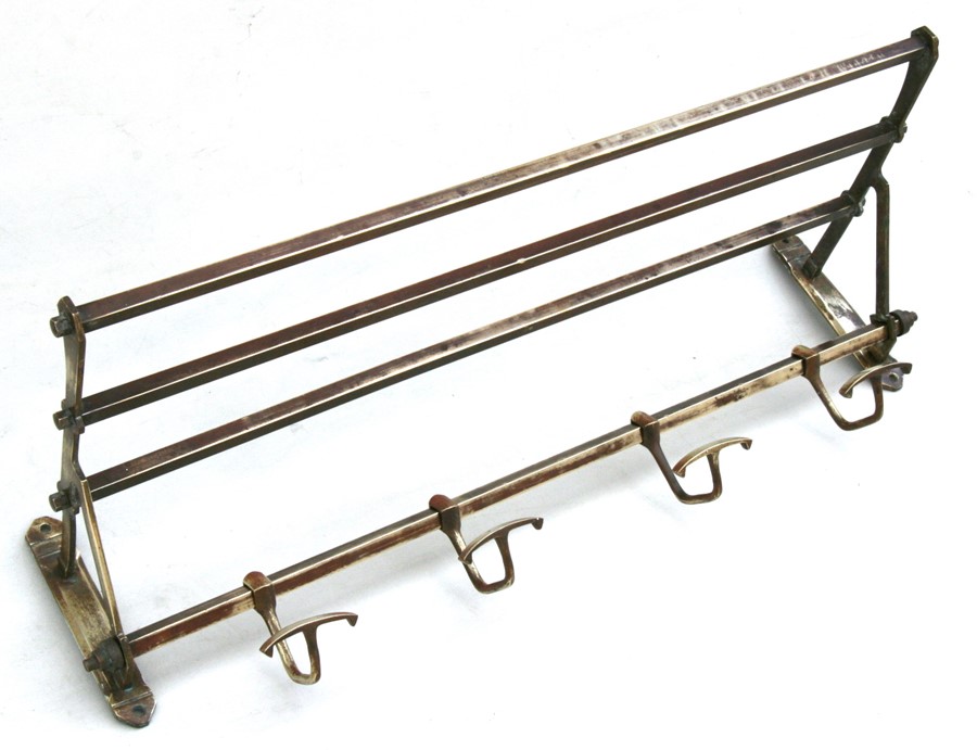 An Edwardian brass coat hook and luggage rack, 67cms (26.5ins) wide.