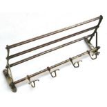 An Edwardian brass coat hook and luggage rack, 67cms (26.5ins) wide.