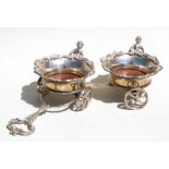 A Victorian style silver plated wine bottle trolley, the pair of coasters with applied figures, on