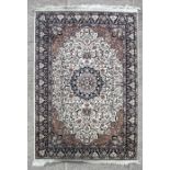 A Persian rug with stylised flowers on a cream ground, 236 by 142cms (93 by 56ins)