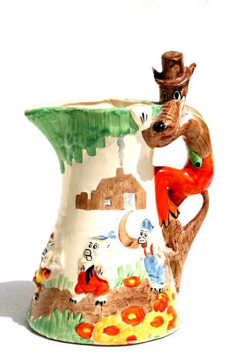 An Art Deco Walt Disney ceramic jug decorated in relief with the Three Little Pigs, the handle