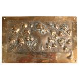An Arts & Crafts brass plaque decorated in relief with a bird and foliage, 24 by 15cms (9.5 by