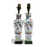 A pair of Chinese famille rose table lamps of square tapering form, decorated with flowers, 27cms (
