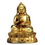 A Tibetan gilded bronze figure of a monk, 11cms (4.25ins) high.Condition ReportSome losses to gilded