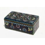 A late 19th century / early 20th century Japanese cloisonne box decorated with butterflies on a deep
