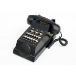 A black Bakelite exchange telephone.