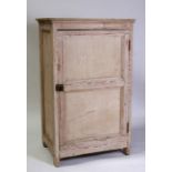 A stripped pine larder cupboard with panelled door and shelved interior, 75cms (29.5ins) wide.