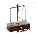A set of apothecary scales with glass pans and weights, retailed by 'Sanger's Ltd', 27cms (10.