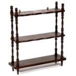 A set of three-tier wall shelves on turned supports, 50cms (19.75ins) wide.