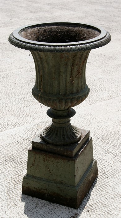 A cast iron campana shaped urn on stand. 68cm (26.75 ins) high