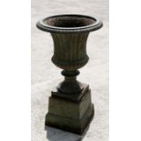 A cast iron campana shaped urn on stand. 68cm (26.75 ins) high