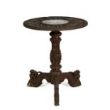 A late 19th century heavily carved Burmese hardwood occasional table on turned & carved column and