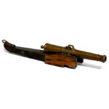 A 19th century bronze barrelled signal cannon mounted on a wooden carriage. Barrel length 19cms (7.
