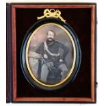 A 19th century daguerreotype of an Officer in a bow top oval frame, housed in a leather travel case,