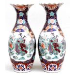 A large pair of Chinese vases decorated with a lady with attendant in a garden setting, red seal