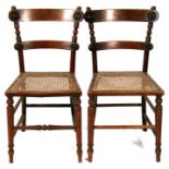 A pair of Regency bedroom chairs with caned seats, on turned front supports (2).