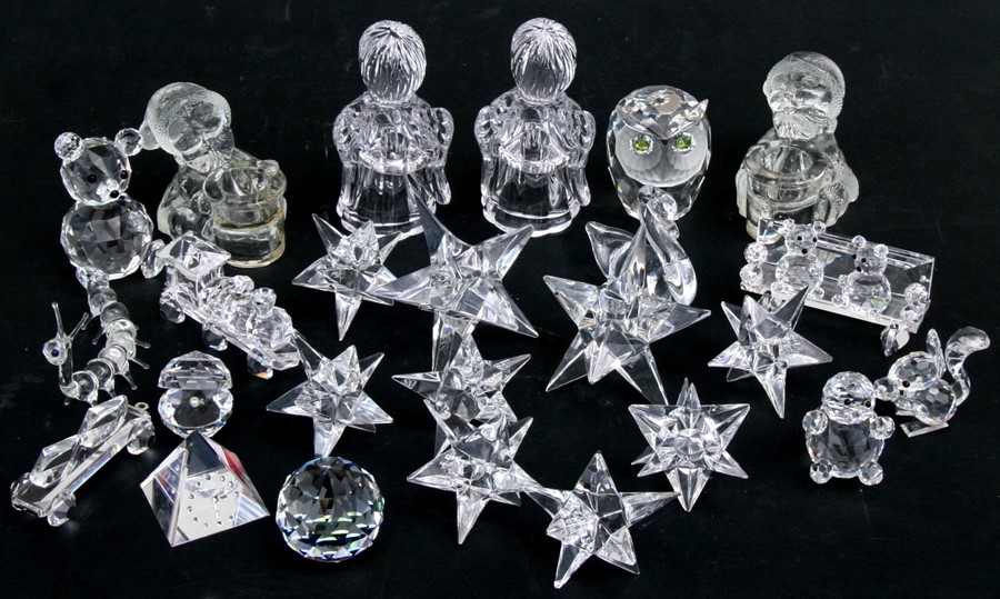 A quantity of Swarovski crystal items including candle holders, animals and similar glassware.