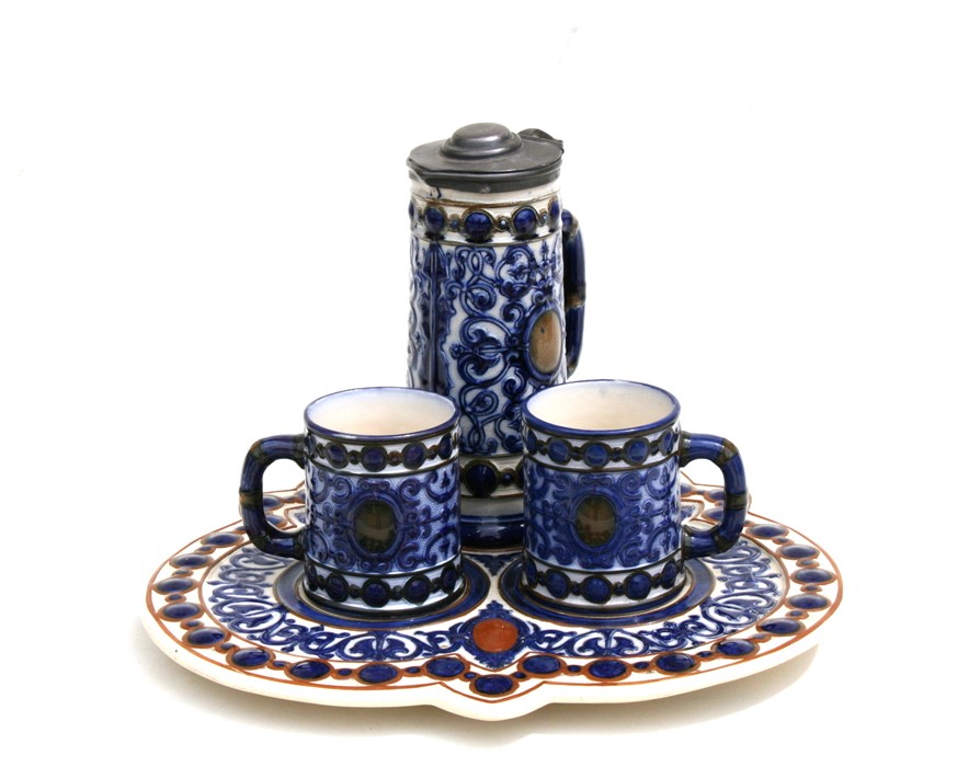 A 19th century majolica beer set consisting of a jug, two tankards and a tray.