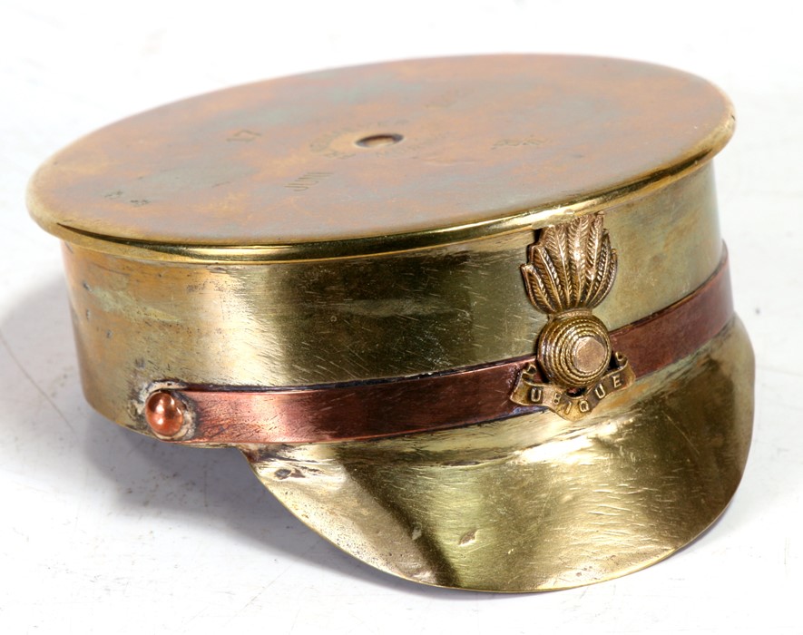 A large WW1 trench art Officers Cap ashtray with Ubique badge. Made from an Imperial German 1915