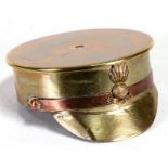 A large WW1 trench art Officers Cap ashtray with Ubique badge. Made from an Imperial German 1915