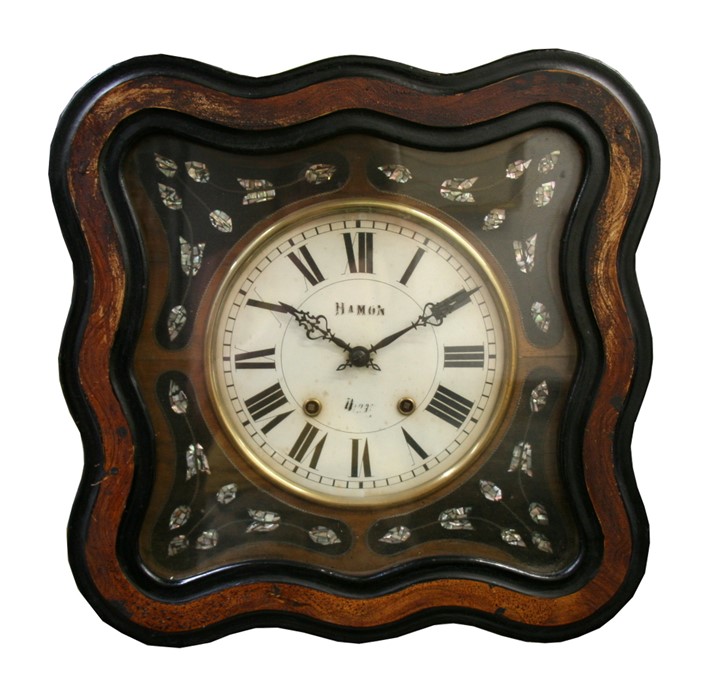 A continental wall clock, the white glass dial with Roman numerals, in an ebonised case with
