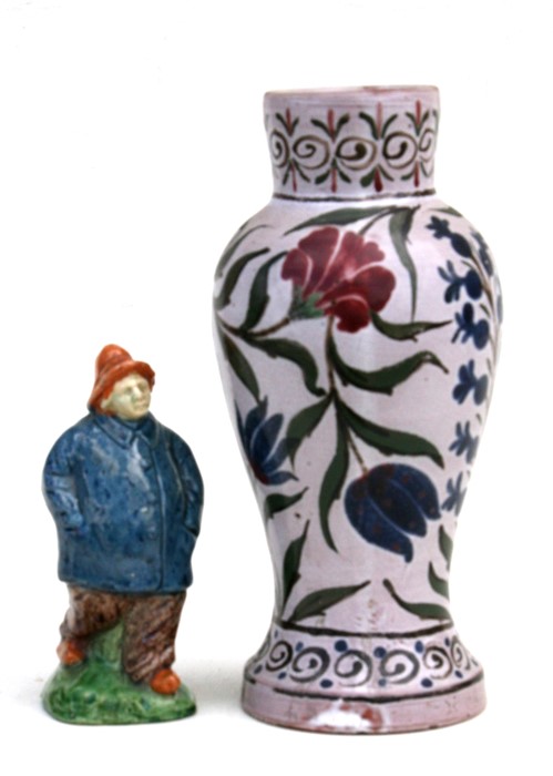 A Persian influence baluster vase, 23cms (9ins) high; together with a pottery figure of a