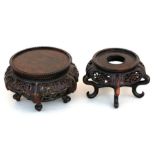 A Chinese pierced hardwood vase stand, on five legs, 12cms (4.75ins) diameter; together with another