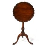 A mahogany tilt-top table, the circular top with pie crust edge, on turned column and tripod base,