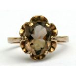 A 9ct gold ring set with an oval smoky quartz, approx UK size 'M'.
