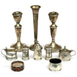 A pair of silver candlesticks; together with a silver bud vase; a silver cruet set and other