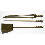 A set of three brass fire irons.