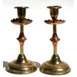 A pair of Benson style Arts & Crafts copper and brass candlesticks, 18cms (7ins) high.