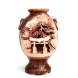 A Japanese pottery vase decorated with a temple, square seal mark to underside, 22cms (8.5ins)