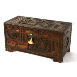A Chinese camphorwood trunk heavily carved with figural scenes, 92cms (36ins) wide.