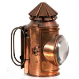 A late 19th / early 20th century copper hand held Police lamp with hooded bulls eye lens, the top