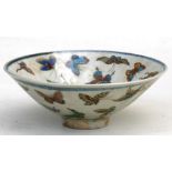 A Chinese footed bowl, highly decorated with butterflies, 17cms (6.75ins) diameter.