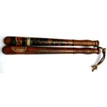 Two Victorian mahogany truncheons with painted decoration, 44cms (17.25ins) long (2).