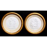 A pair of plaster relief panels depicting classical scenes, framed & glazed, 13cms (5ins) diameter.