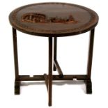 A 20th century Chinese hardwood folding occasional table, the top carved with figures and boats,