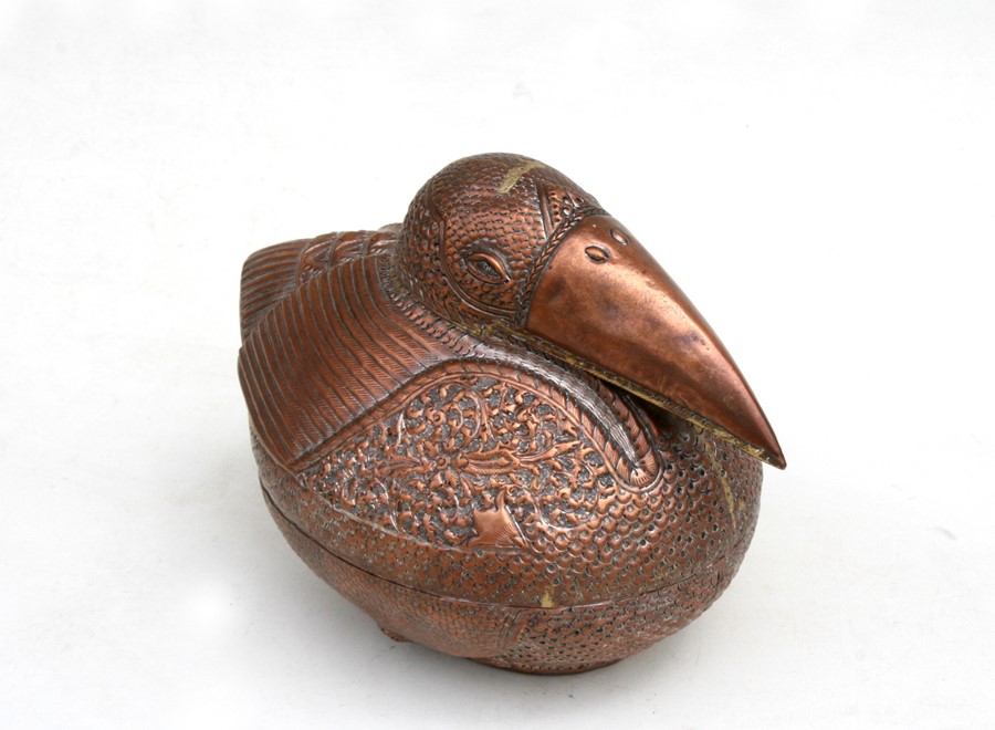 A Cambodian copper betal nut / leaf box in the form of a bird, decorated with foliate scrolls with