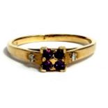 A 9ct gold dress ring set with four amethysts and two diamonds to the shoulders, approx UK size '
